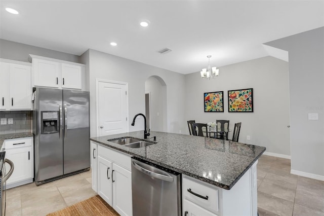 kitchen with sink, white cabinetry, stainless steel appliances, and an island with sink