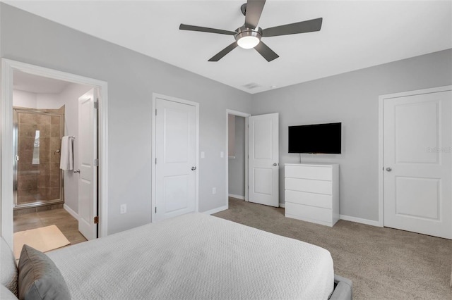 bedroom featuring ceiling fan, ensuite bathroom, and light carpet