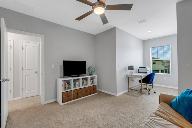 carpeted office space featuring ceiling fan