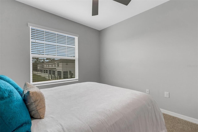 bedroom featuring ceiling fan and carpet