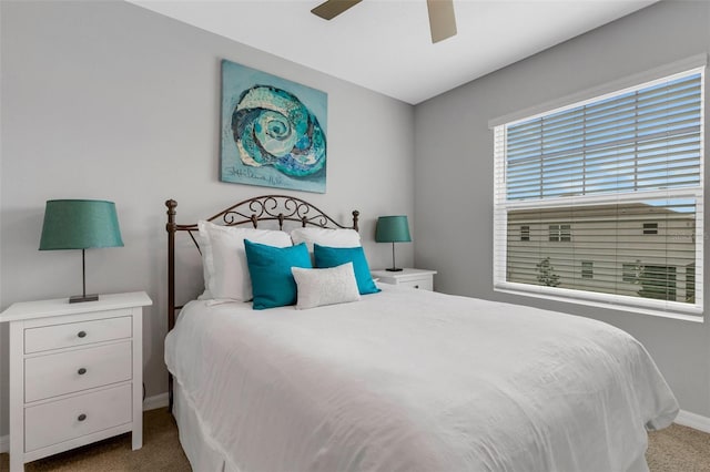 bedroom with ceiling fan and light carpet