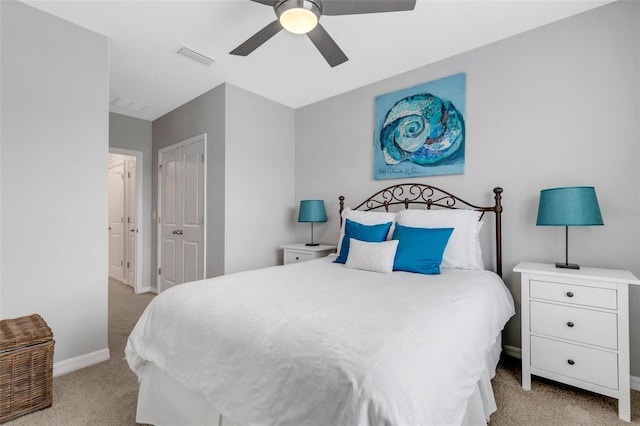 carpeted bedroom with ceiling fan and a closet