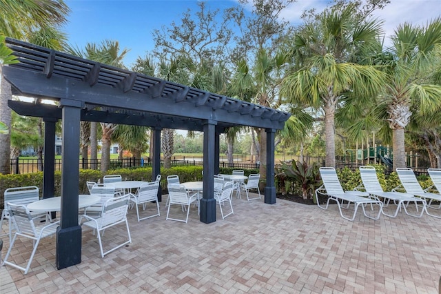 view of patio with a playground and a pergola