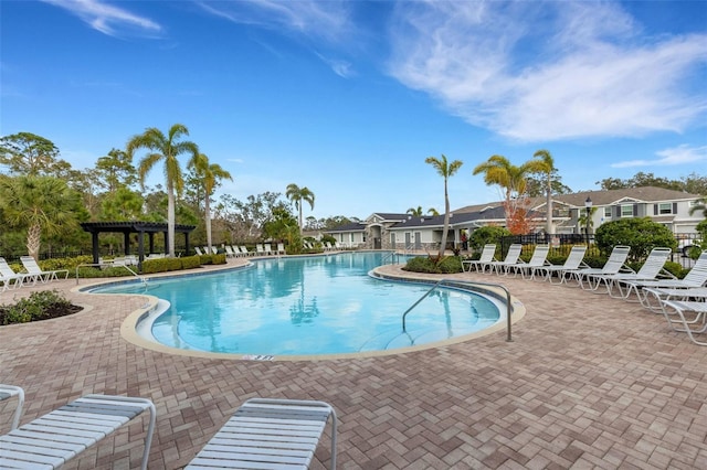 view of pool with a pergola and a patio