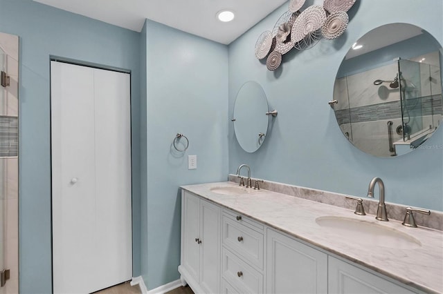 bathroom featuring vanity and a shower with shower door