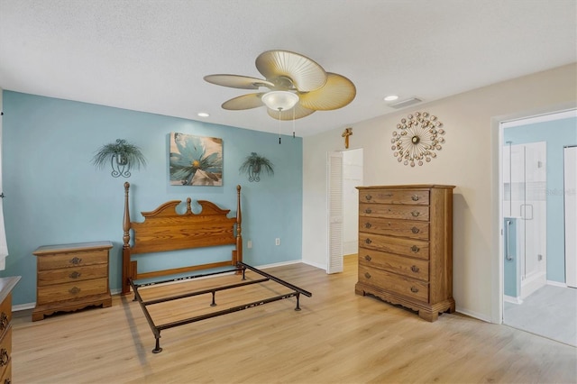 bedroom with ceiling fan, light hardwood / wood-style flooring, a closet, and a textured ceiling