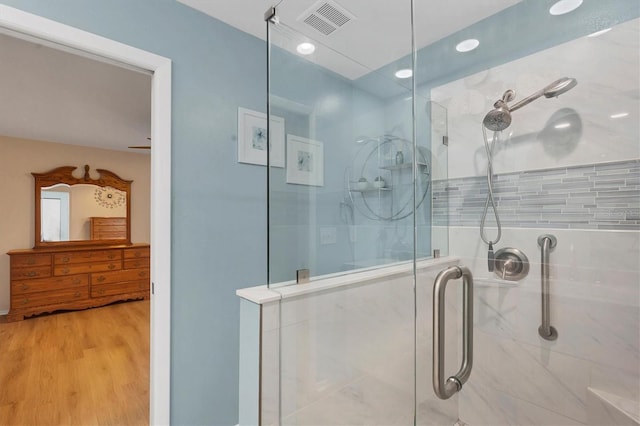 bathroom with walk in shower and wood-type flooring