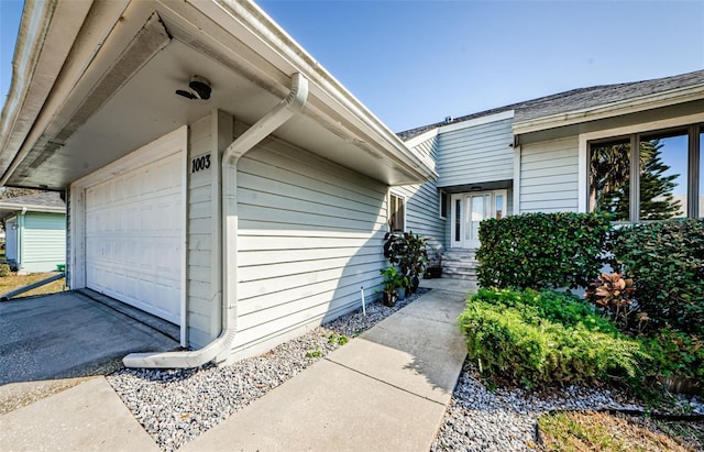 doorway to property with a garage