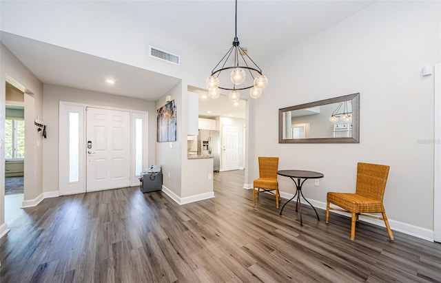 entrance foyer featuring a chandelier and dark hardwood / wood-style flooring