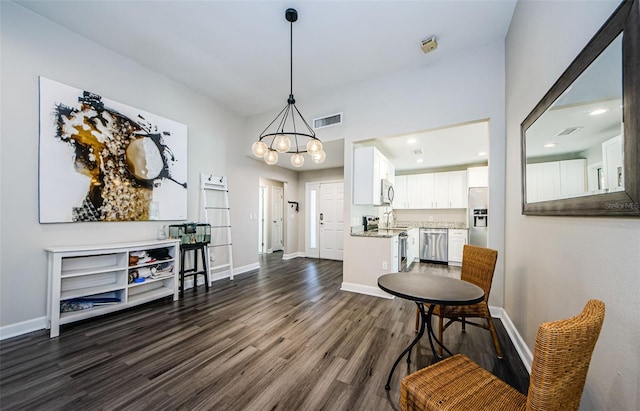 interior space featuring dark hardwood / wood-style floors and an inviting chandelier