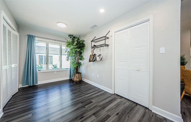 unfurnished bedroom featuring dark hardwood / wood-style flooring