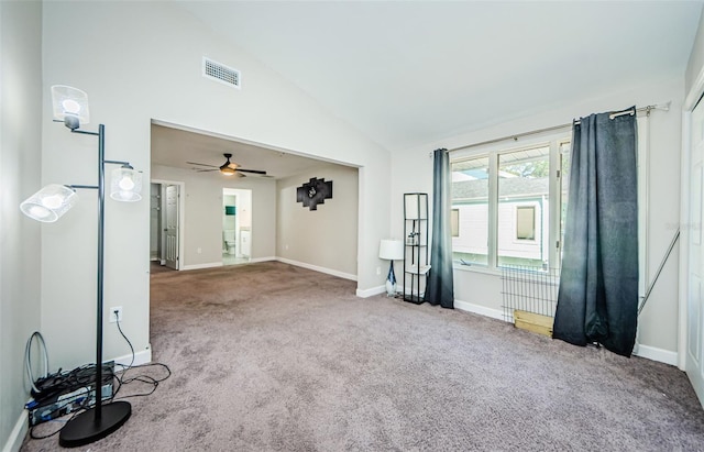 unfurnished room with carpet flooring, vaulted ceiling, and ceiling fan