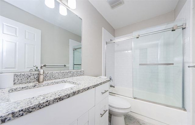 full bathroom with vanity, toilet, and bath / shower combo with glass door