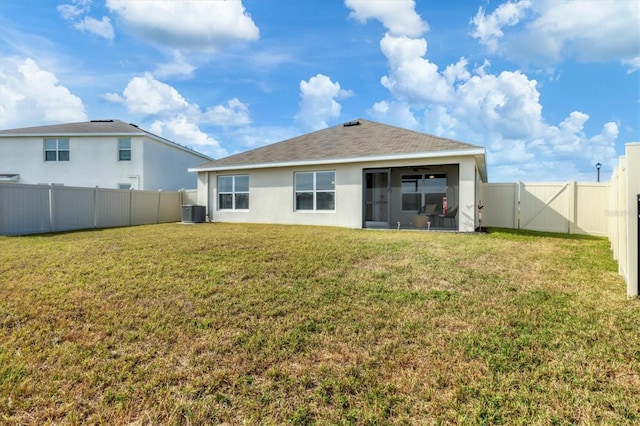 back of property featuring cooling unit, a sunroom, and a lawn