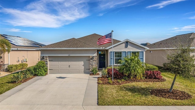 ranch-style home with a front lawn and a garage