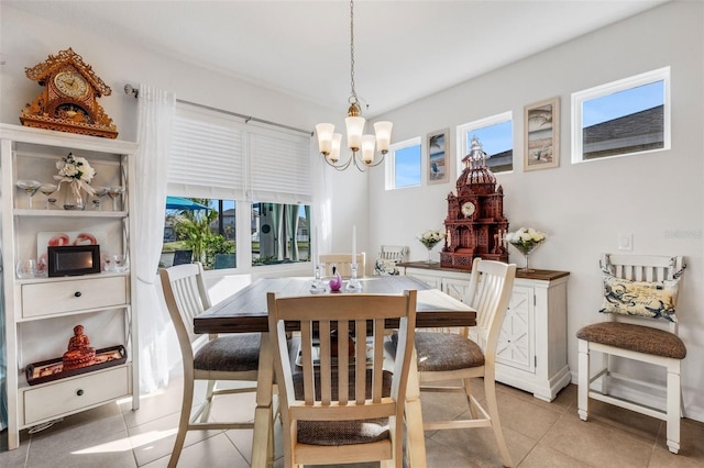 tiled dining area featuring an inviting chandelier and a wealth of natural light