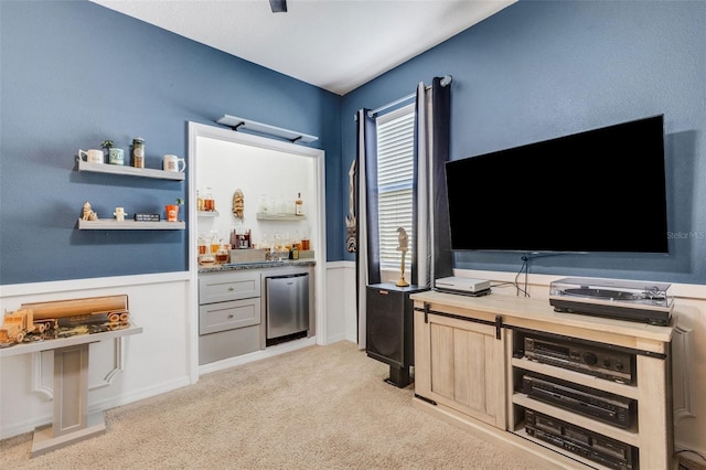 bar with light brown cabinetry, light colored carpet, refrigerator, and wood counters