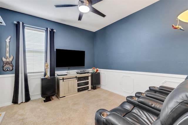 carpeted living room with ceiling fan