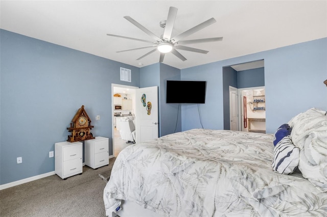 carpeted bedroom featuring ceiling fan, a spacious closet, and a closet