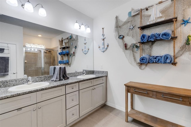 bathroom with vanity, an enclosed shower, and tile patterned floors