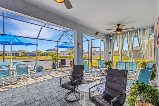 view of patio featuring ceiling fan and a lanai