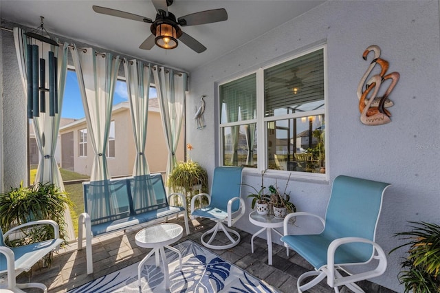 sunroom with ceiling fan