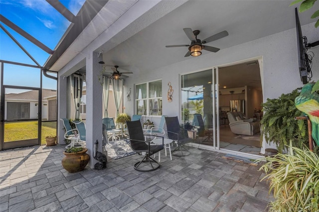 sunroom / solarium featuring ceiling fan