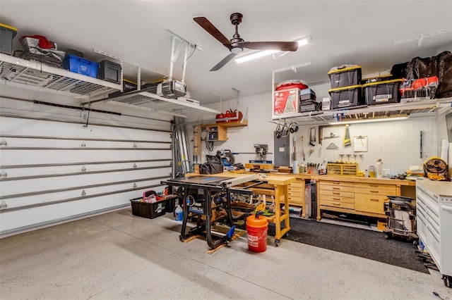 garage featuring ceiling fan, a workshop area, and a garage door opener