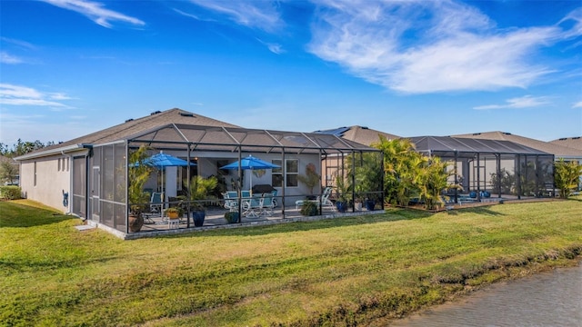 rear view of property featuring a lanai, a patio area, and a lawn