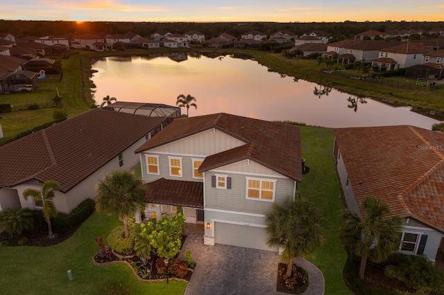 aerial view at dusk with a water view