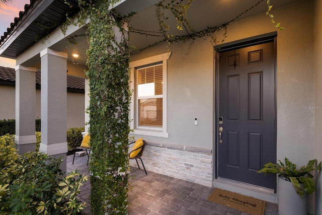 exterior entry at dusk with covered porch