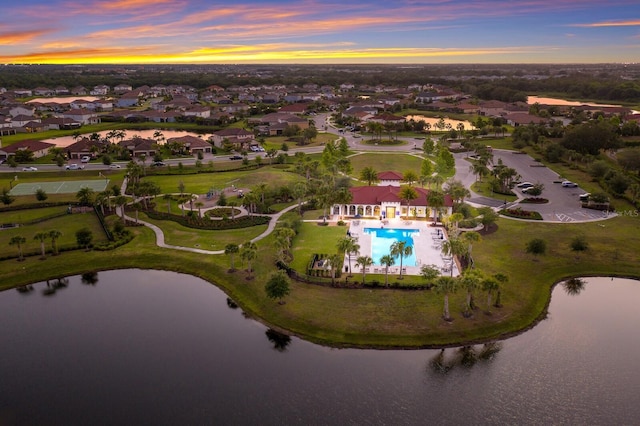 aerial view at dusk with a water view