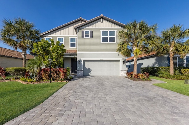 view of front of home with a garage and a front lawn