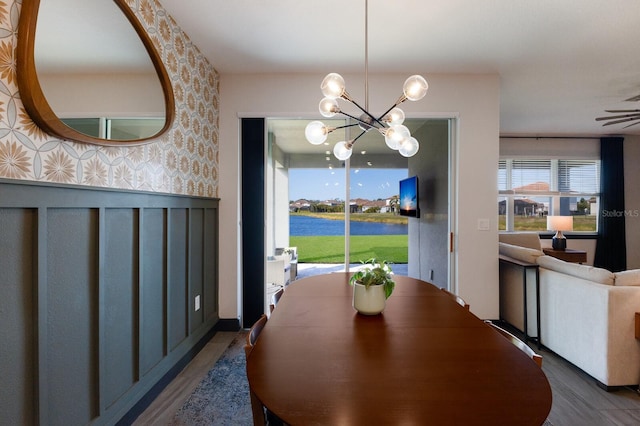 dining area with an inviting chandelier and dark wood-type flooring