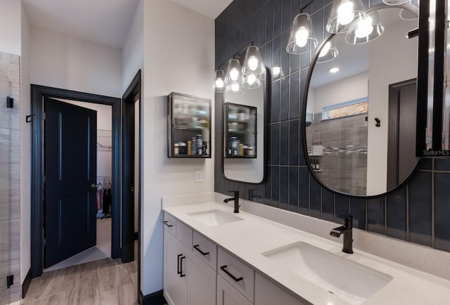 bathroom with backsplash, a shower with door, and vanity