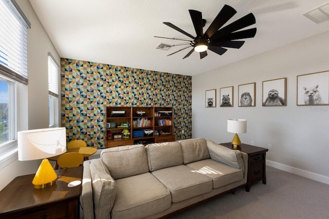 living room with ceiling fan and carpet