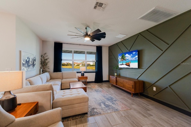 living room featuring ceiling fan and light hardwood / wood-style flooring