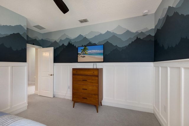 unfurnished bedroom with ceiling fan and light colored carpet