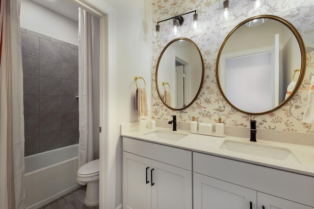 full bathroom featuring toilet, shower / bath combination with curtain, and vanity