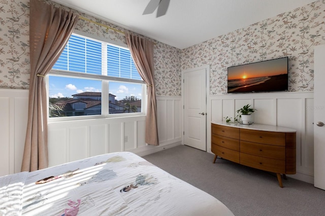 bedroom with ceiling fan and light carpet