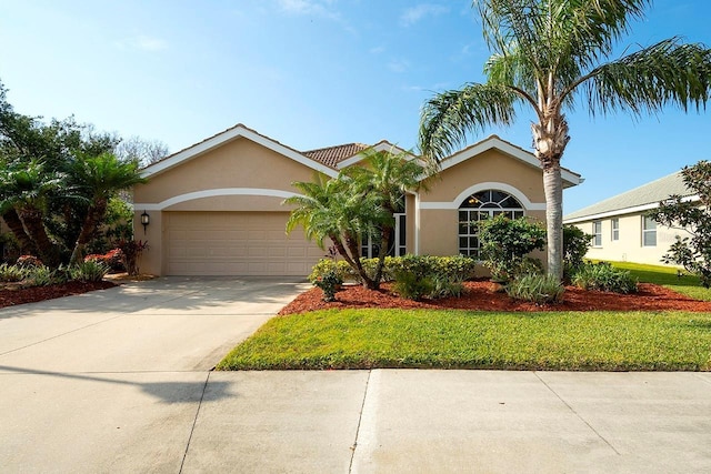 ranch-style house featuring a front lawn and a garage