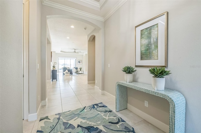 hall featuring light tile patterned flooring and ornamental molding