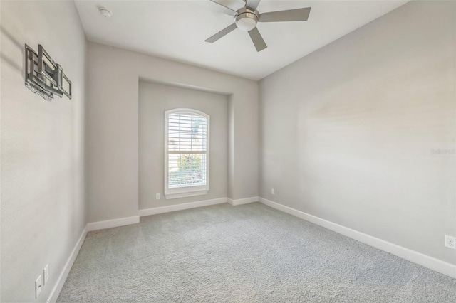 spare room featuring carpet floors and ceiling fan