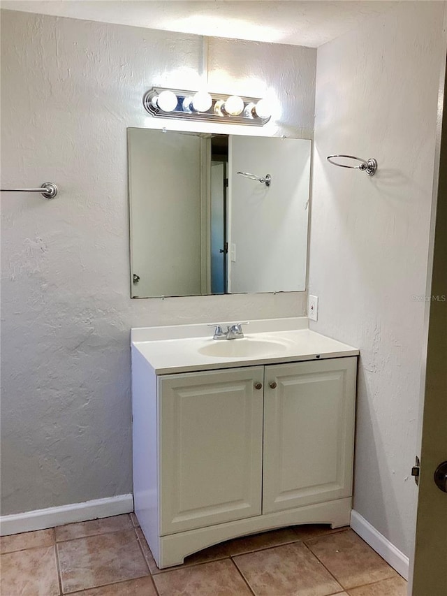 bathroom featuring tile patterned flooring and vanity