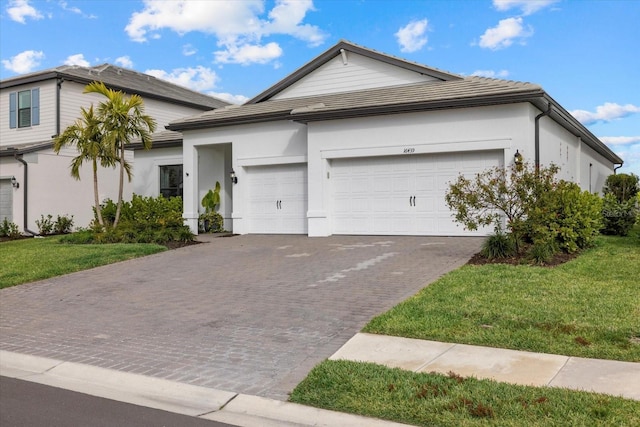 view of front of home with a garage and a front yard