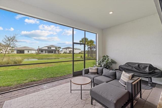 sunroom / solarium with a water view