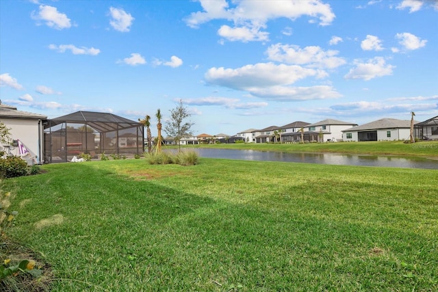 view of yard featuring a water view and a lanai