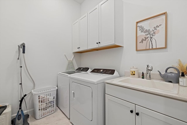 laundry area with cabinets, light tile patterned flooring, independent washer and dryer, and sink