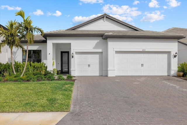 view of front of property with a front lawn and a garage