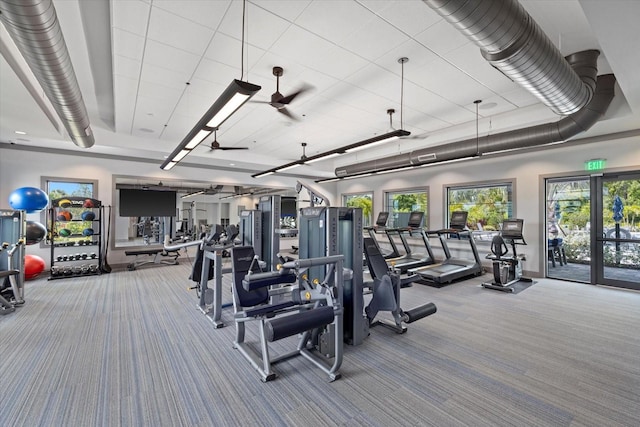 exercise room with ceiling fan and carpet